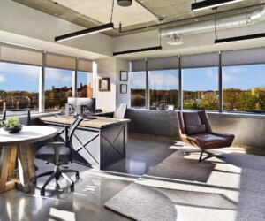 A modern office with large windows offers views of trees and buildings. The room features a desk with a computer, two chairs, a round table, a brown leather chair, and a plant—all set on durable commercial kitchen flooring. A modern office with large windows offers views of trees and buildings. The room features a desk with a computer, two chairs, a round table, a brown leather chair, and a plant—all set on durable commercial kitchen flooring.
