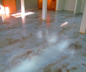 A room featuring smooth, glossy marbled epoxy flooring Connecticut in shades of gray and brown, reflecting light from windows and wooden doors. White posts are spaced throughout the space, creating a sleek and inviting atmosphere. A room featuring smooth, glossy marbled epoxy flooring Connecticut in shades of gray and brown, reflecting light from windows and wooden doors. White posts are spaced throughout the space, creating a sleek and inviting atmosphere.