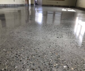 A close-up view of a polished concrete floor with small aggregate stones, highlighting a smooth, shiny surface—perfect inspiration for those seeking epoxy flooring Connecticut or durable industrial floor coating solutions. A close-up view of a polished concrete floor with small aggregate stones, highlighting a smooth, shiny surface—perfect inspiration for those seeking epoxy flooring Connecticut or durable industrial floor coating solutions.